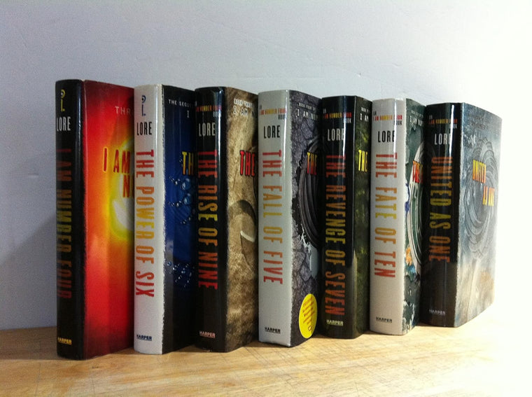 Reference image of the seven Lorien Legacies hardcover titles; actual copies may differ.